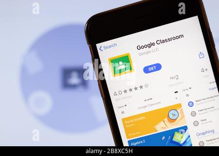 Los Angeles, California, USA - 24 March 2020: Google Classroom app logo on phone screen close up with website on background with icon, Illustrative Stock Photo
