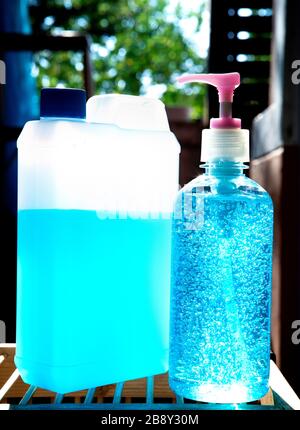 hand sanitizer gel bottle for hand hygiene corona virus protection standing outdoor against sun light Stock Photo
