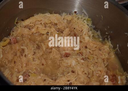 Sauerkraut in a pot with some Salami Stock Photo