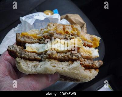 McDonald's restaurants in the UK close at 7pm 19.00 hrs in the UK as part of the Coronavirus Covid-19 outbreak.  Pictured, cars using a drive through at a McDonald's Stroud, Gloucestershire. Pictured, a McDonald's double sausgae and egg McMuffin meal.           by Gavin Crilly Photography, NO SALES, NO SYNDICATION contact for more information mob: 07810638169 web: www.pressphotographergloucestershire.co.uk email: gavincrilly@gmail.com    The photographic copyright (© 2015) is exclusively retained by the works creator at all times and sales, syndication or offering the work for future publicati Stock Photo