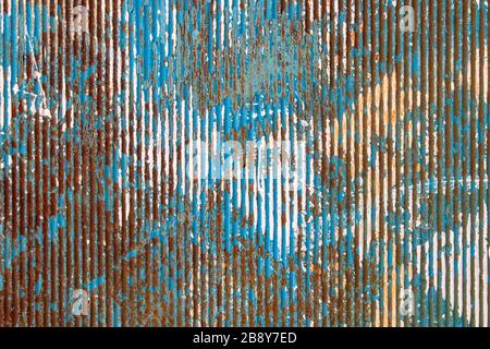 Peeling paint on rusty corrugated metal Stock Photo