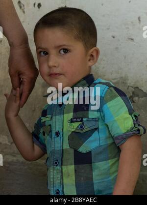 Yemtz, Tajikistan - June 17, 2020: Shy boy in the Bartang Vally at the Pamir Highway in Tajikistan. Stock Photo