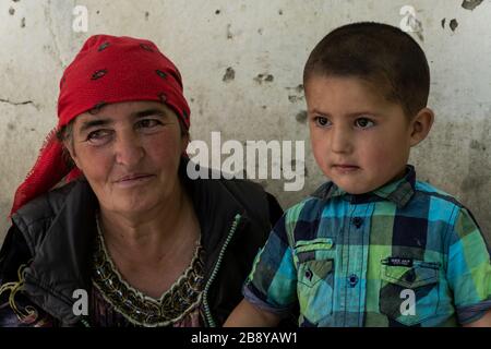 Yemtz, Tajikistan - June 17, 2020: Family with mother and child in the Bartang Vally at the Pamir Highway in Tajikistan. Stock Photo