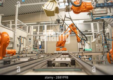 robot arms in the factory performs precise work according to the specified program Stock Photo