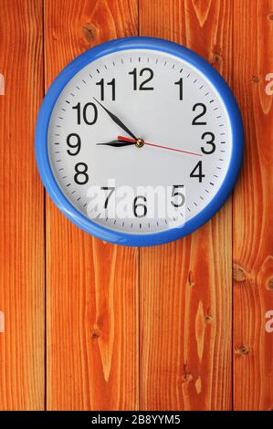 Blue vintage wall clock on a wooden background Stock Photo