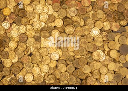 Bed of small golden coins Stock Photo