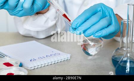 Covid-19. Biochemist or virologist examines blood samples in a laboratory Stock Photo
