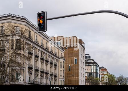 Yellow traffic light in the city and urban cityscape in background. Traffic light and city concept Stock Photo