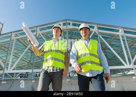 Industrial portrait of two men working at construction site. Building, development, industry and people concept Stock Photo