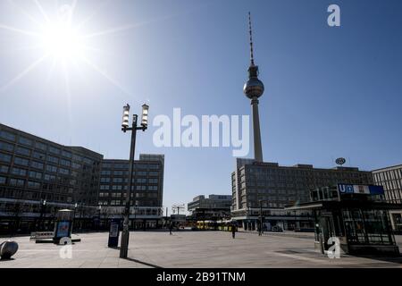 Berlin, Germany. 23rd Mar, 2020. Few people are on the move at Alexanderplatz. Credit: Britta Pedersen/dpa-Zentralbild/dpa/Alamy Live News Stock Photo