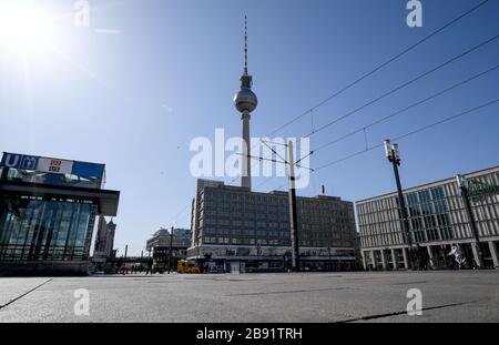 Berlin, Germany. 23rd Mar, 2020. Few people are on the move at Alexanderplatz. Credit: Britta Pedersen/dpa-Zentralbild/dpa/Alamy Live News Stock Photo