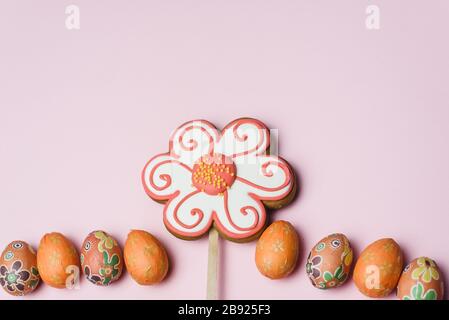 Samara Russia - 03.01.2020: Easter gingerbread, sweet colored candies and small, decorative eggs on a pink background. Easter card. Stock Photo