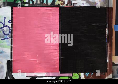 Blank textured street posters on grungy city wall. Background frame design element to overlay your photos and text. Stock Photo