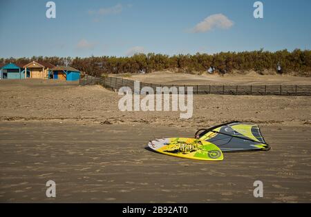 Winsufer laying unused on a sandy beach Stock Photo