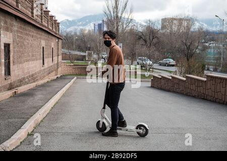 Young man riding a scooter in the city Stock Photo