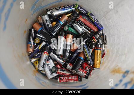 Athens, Greece - December 21, 2019: Pile of used alkaline batteries in battery recycling container. Stock Photo
