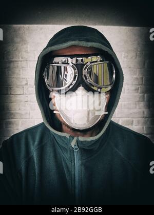 Portrait of a man in a protective mask and mirror glasses. Stylized portrait of a pandemic face Stock Photo