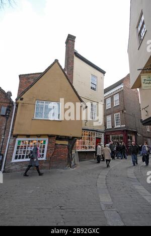 A cluster of 15th century buildings and shops in Low Petergate and The shambles in the old quarter of York, England. Stock Photo