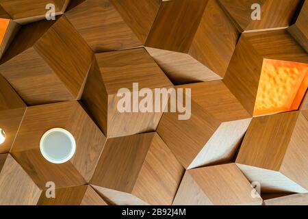 Lights and Speakers Drop Ceiling Wooden Texture Tiles. Hexagon Metal Timber Panels. Three Dimensional Cube Shape Decoration. Bottom View. Stock Photo