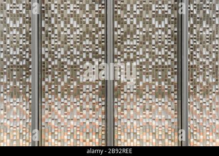 Facade Golden Glass Panels with Grey Color Frames. Reflecting and Metallic Gradient Texture. Stock Photo