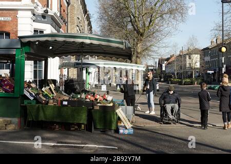 London, UK. 23rd Mar, 2020. COVID-19. Fresh Air Library at Foster's Bookshop in Chiswick High Road offers free books as cyclists and runners take advantage of the open spaces. Credit: Peter Hogan/Alamy Live News Stock Photo