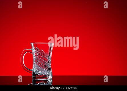 Crystal glasses shot close-up on a red background Stock Photo