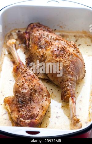 baked goose legs with cumin in frying pan Stock Photo