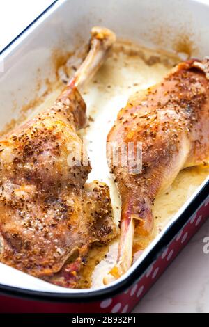 baked goose legs with cumin in frying pan Stock Photo