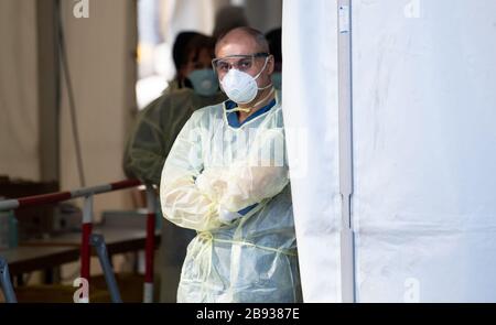 Munich, Germany. 23rd Mar, 2020. Medical personnel work in a new test station in front of the Tropical Institute for people suspected of having Covid-19. Only medical personnel and specific professional groups such as the police or fire brigade are to be tested at the new test station. Credit: Sven Hoppe/dpa/Alamy Live News Stock Photo