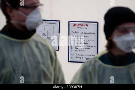 Munich, Germany. 23rd Mar, 2020. Medical personnel work in a new test station in front of the Tropical Institute for people with Covid-19 suspicion. Only medical personnel and specific professional groups such as the police or fire brigade are to be tested at the new test station. Credit: Sven Hoppe/dpa/Alamy Live News Stock Photo