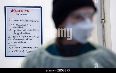 Munich, Germany. 23rd Mar, 2020. Medical personnel work in a new test station in front of the Tropical Institute for people suspected of having Covid-19. Only medical personnel and specific professional groups such as the police or fire brigade are to be tested at the new test station. Credit: Sven Hoppe/dpa/Alamy Live News Stock Photo