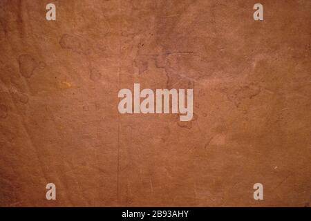 Texture of old brown worn antique leather with spots for background and design Stock Photo