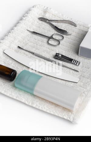 manicure tools set hand nail care on fluffy white towel in spa salon, side view, equipment for manicure Stock Photo