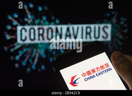China. 20th Mar, 2020. In this photo illustration the China Eastern airline logo seen displayed on a smartphone with a computer model of the COVID-19 coronavirus on the background. Credit: Budrul Chukrut/SOPA Images/ZUMA Wire/Alamy Live News Stock Photo