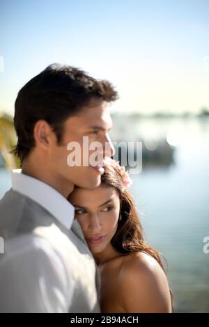 Portrait of a young newlywed couple tenderly embracing after their wedding. Stock Photo