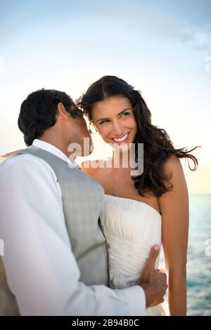 Portrait of a young newlywed couple tenderly embracing after their wedding. Stock Photo