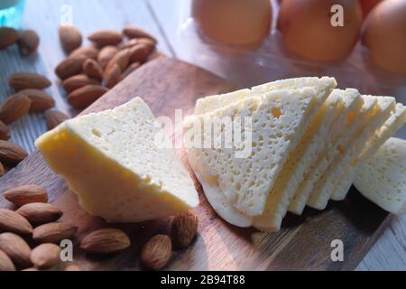 piece of cheese, almond and egg on table  Stock Photo
