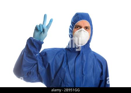 Doctor in protective clothing showing V Stock Photo