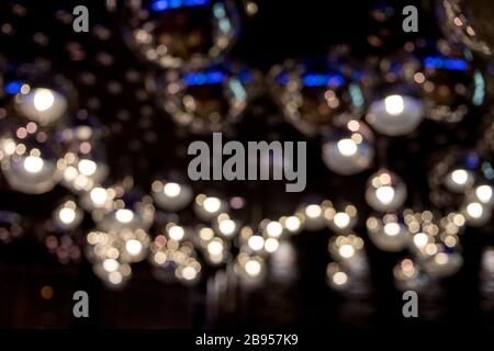 Rays and highlights of silver lamps, lampshade. Anstract background of Silver circles, decor, art. Defused shiny background. Many silver lamps. night Stock Photo