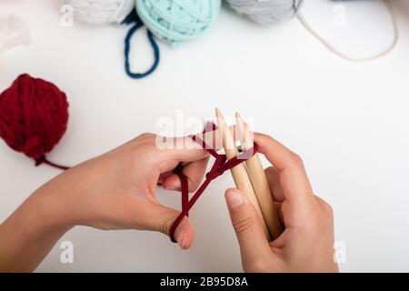 Children hands are knitted and crocheted view frome above on white table Stock Photo