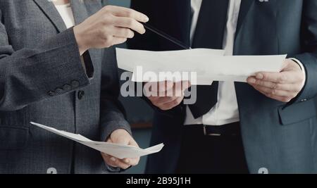 Midsection of businesspeople discussing issues Stock Photo