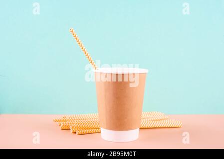 Paper glass with drinking tubes. Eco utensils on a light background. Zero waste.Sustainable lifestyle concept Stock Photo