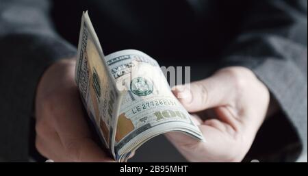 Hands counting US dollar banknotes Stock Photo