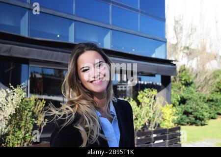 Portrait of a young beautiful business woman outside her office. Stock Photo