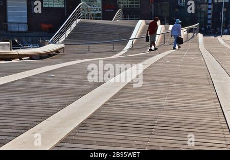 Couple walking on the boardwalk in waterfront, Spadina WaveDeck, Toronto. Stock Photo