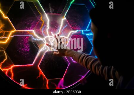 Woman using interactive touchscreen exposition in science museum. Stock Photo