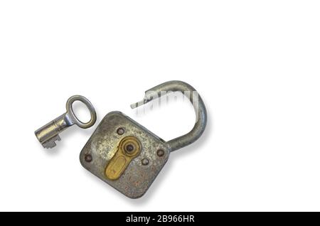 rusty old padlock with key, close up, isolated on white background Stock Photo