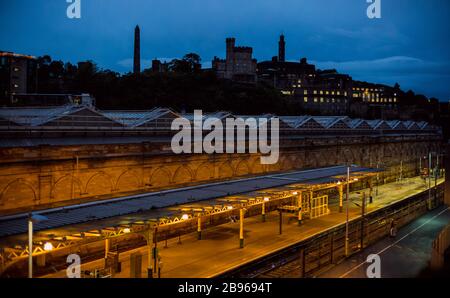 Edinburgh Waverly railway and train station completely empty at dusk with castle in the background.  Edinburgh, Scotland, United Kingdom Stock Photo