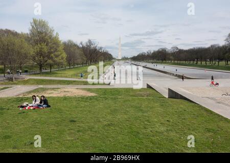 Reflecting Pool on Washington, DC Mall, undergoing draining, cleaning and repairs, attracts tourists during covid-19 restrictions. Mar. 22, 2020 Stock Photo
