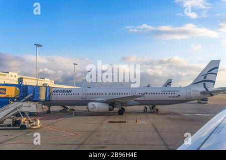 Aegean airlines aircraft grounded at airport tarmac. Greek flag carrier Airbus A321 parked on Athens International Airport Eleftherios Venizelos. Stock Photo
